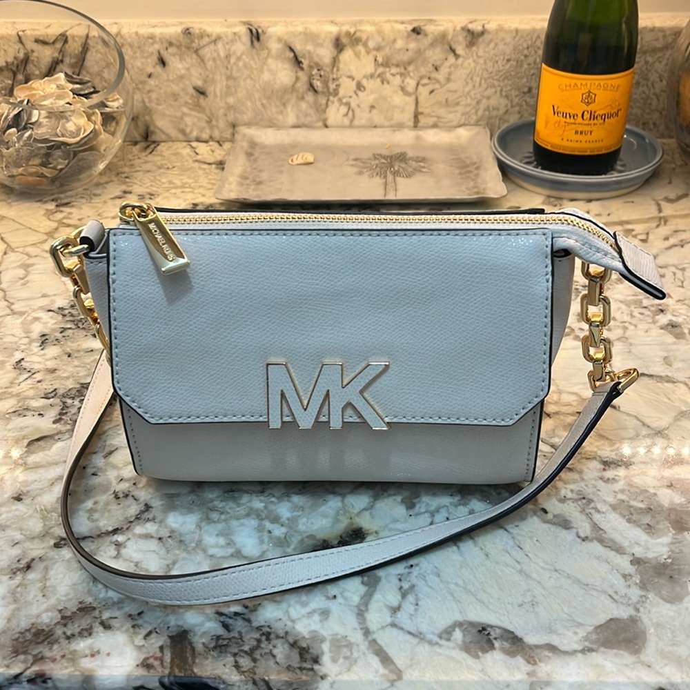 Michael Kors Vanilla Florence Crossbody Chain link attached to leather strap.